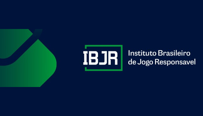 Um grupo de pessoas protestando com cartazes pedindo o bloqueio de jogos ilegais, com o logotipo do IBJR ao fundo.